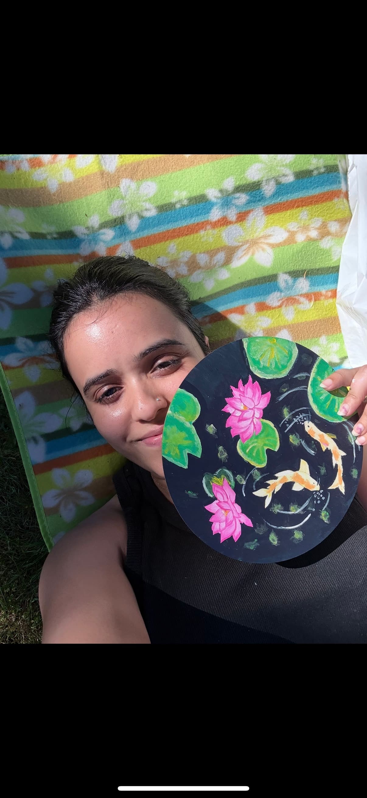 Ritu holding her colorful spin art work