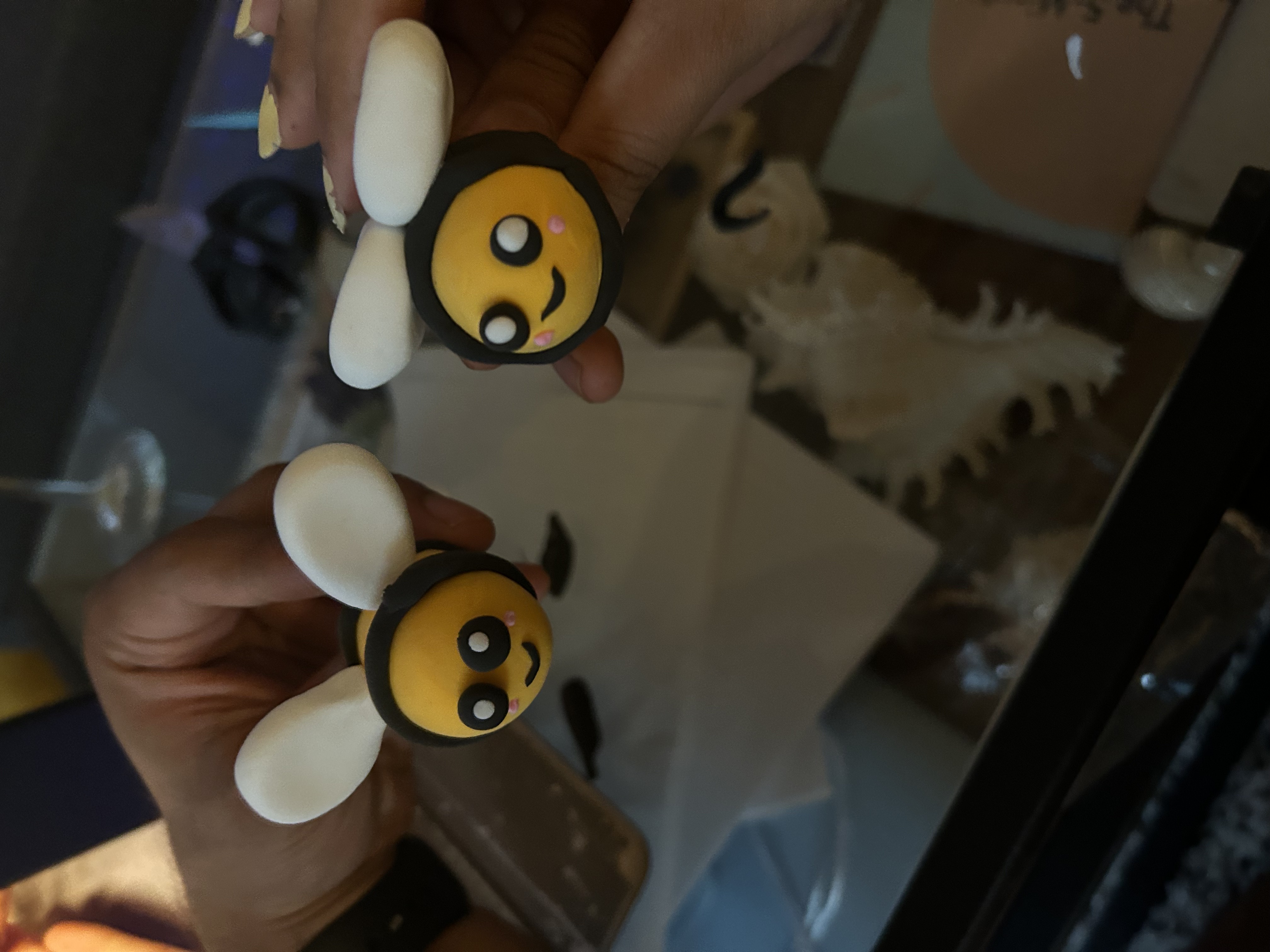 Two bee-shaped clay pieces